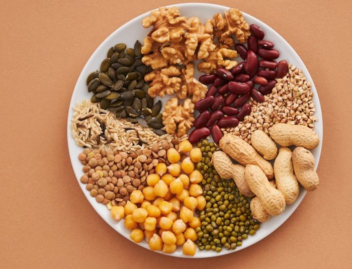 Top view of nuts, beans, and seeds on a plate, ideal for healthy dining themes.